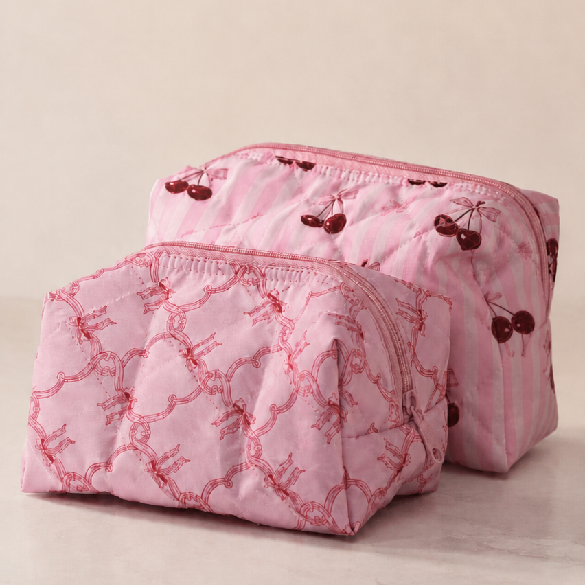 Pink quilted makeup bag with floral patterns on a beige background