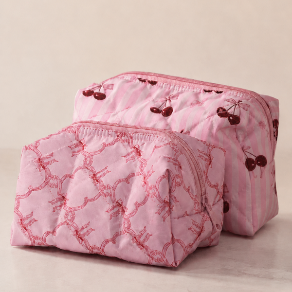 Pink quilted makeup bag with floral patterns on a beige background