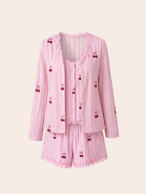 Pink pajama set with cherry details on a white background