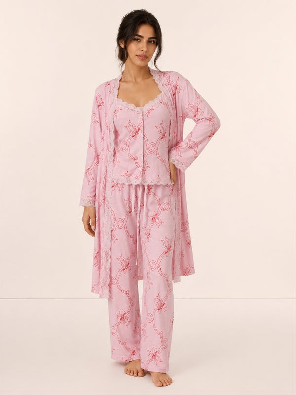 Woman wearing a pink floral pajama set on a white background
